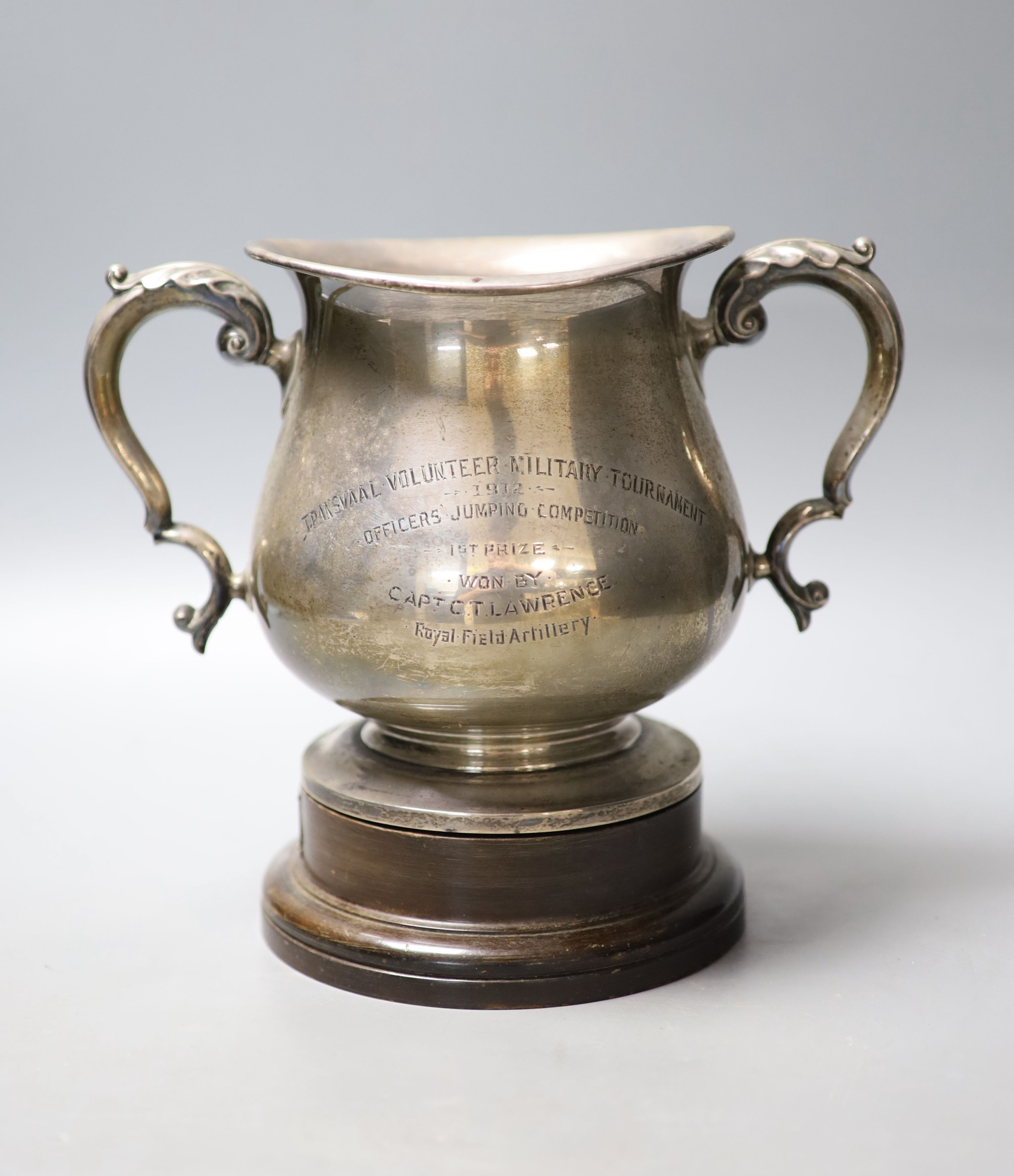 An Edwardian silver two handled presentation trophy cup, with later engraved inscription relating to the 'Transvaal Volunteer Military Tournament' Mappin & Webb, London, 1908, height 15.6cm, 21.5oz, on a wooden socle.